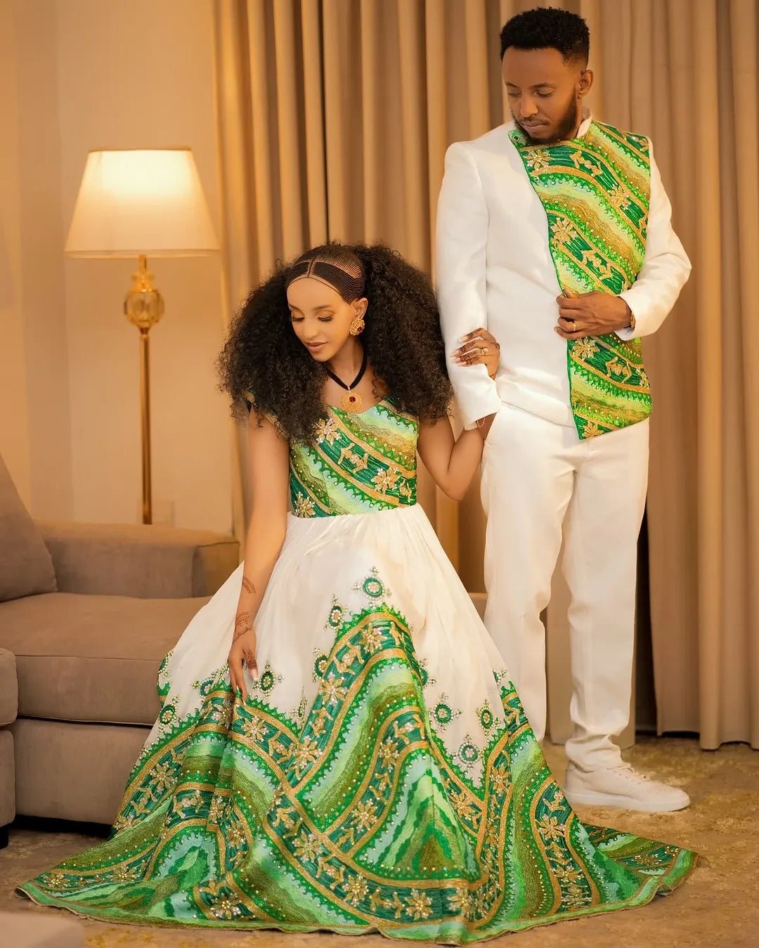 Couple in formal attire with green and white patterns in a room.