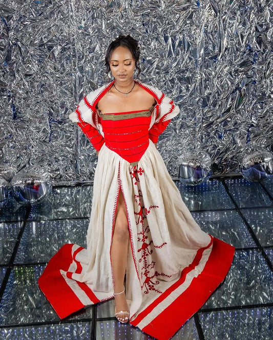 Woman in a red and white outfit with a textured silver background