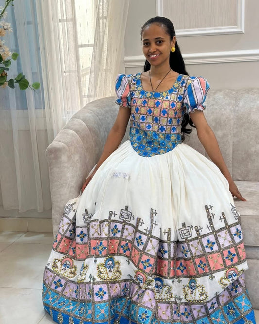 Woman wearing a colorful traditional outfit with a white background