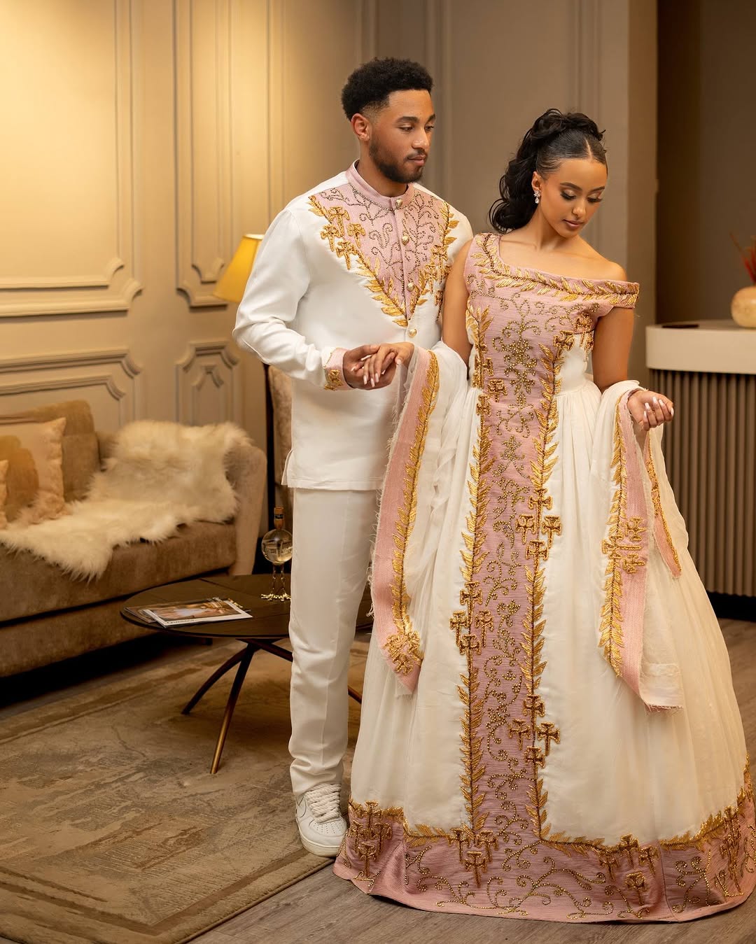 Man and woman in formal attire standing in a decorated room.