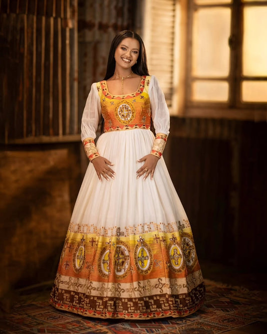 Woman wearing a traditional outfit with a white and orange patterned dress in a warm-toned room.