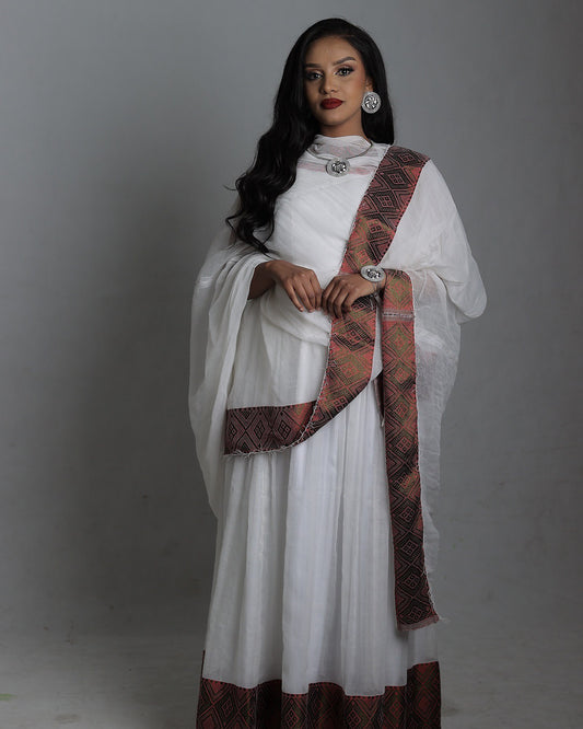 Woman wearing a white traditional outfit with a red and gold sash on a gray background