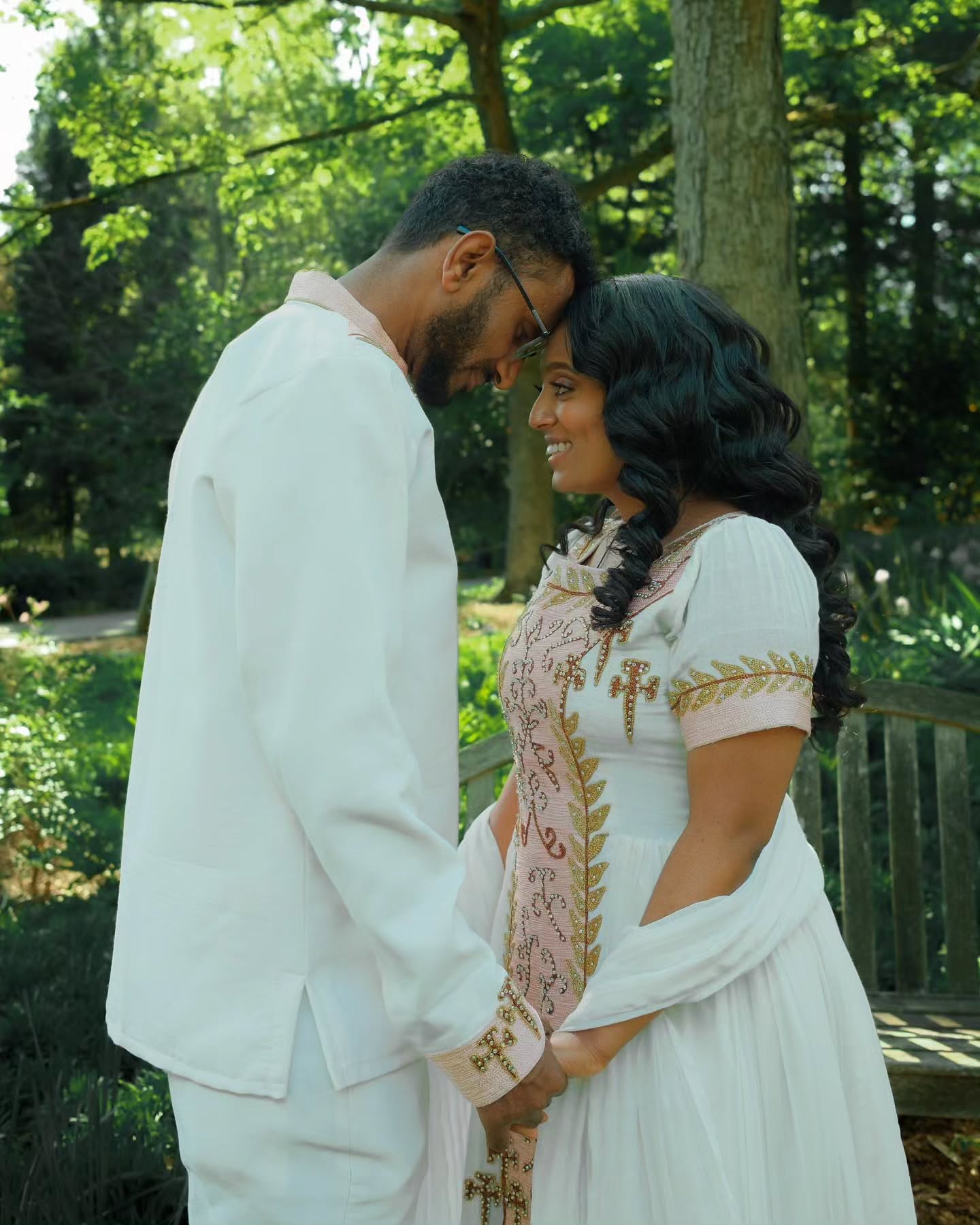 VERONICA ETHIOPIAN WEDDING COUPLE OUTFIT | WHITE HABESHA DRESS AND MEN’S SUIT | GOLD AND PINK EMBROIDERY COUPLES OUTFIT